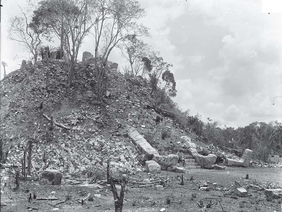 Maudslay's 1889 photograph of the Ossuary (or as he called it, Mound No. 9) taken at ground level and showing the serpent-headed balustrades and remains of the temple at the top