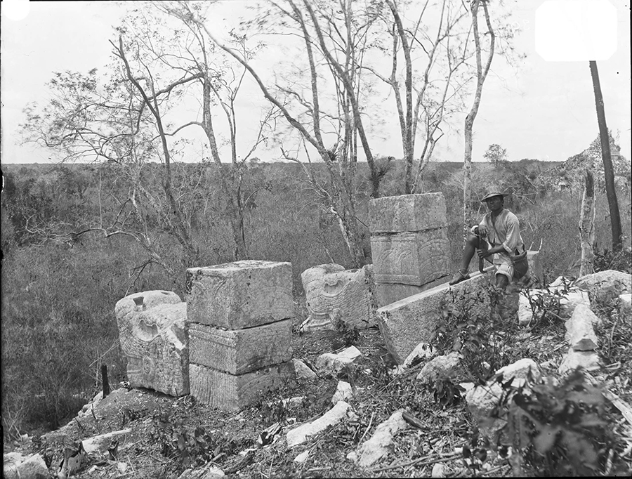 Maudslay's Photo from 1889 from the temple atop the Ossuary showing serpent-headed columns in front of the Temple