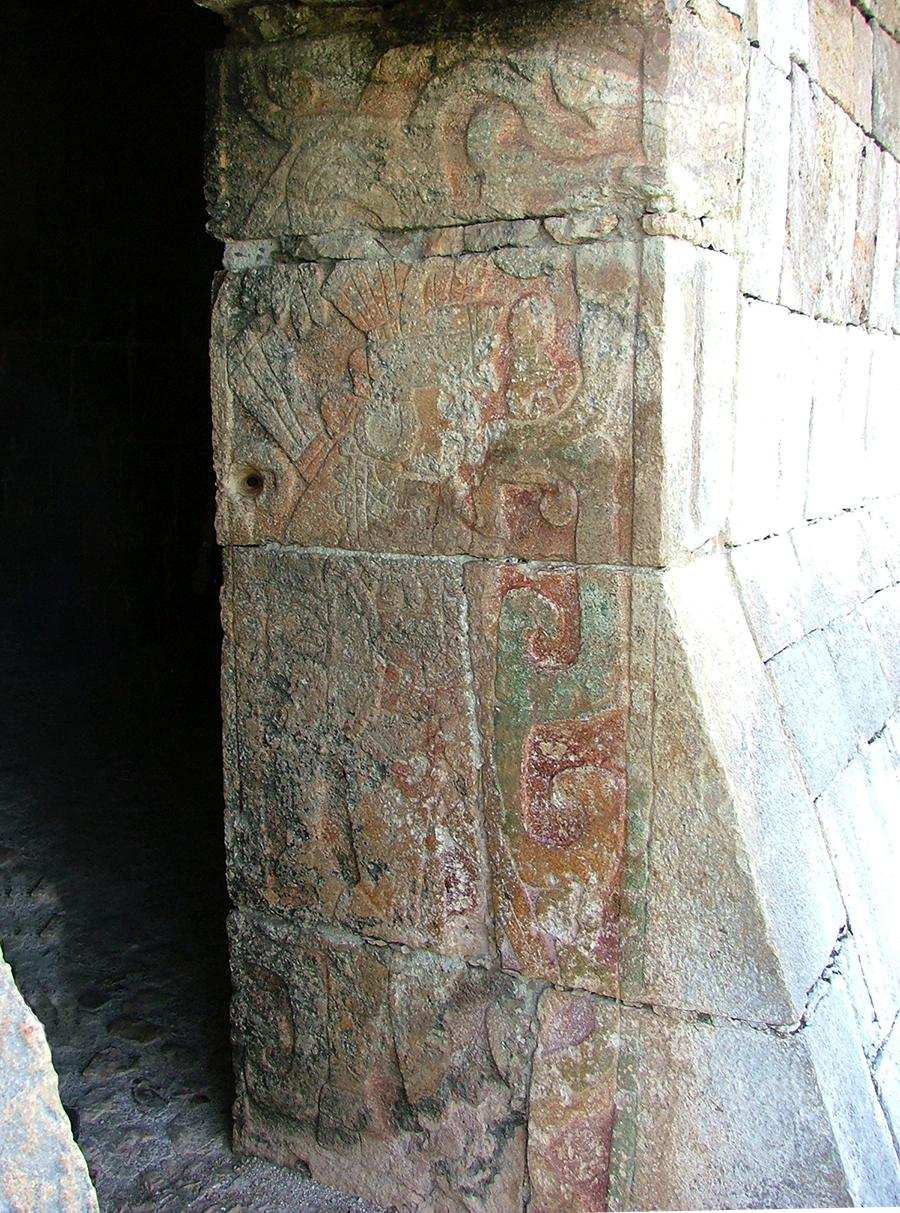 Doorjamb of the central doorway of the Temple of Kukulkan looking inward  showing carved warrior and remnants of red, green and yellow paint