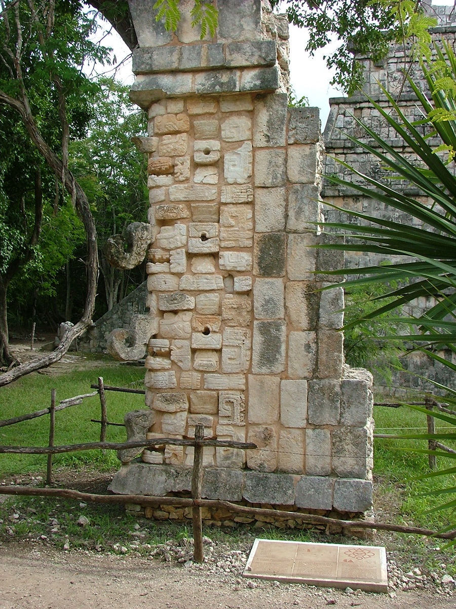 Photo of the Chaak mask stack which once formed the corner wall of the Ossuary Temple, now reassembled in front of the Temple on the ground