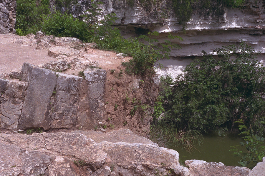 Carved detail near the structure on the lip of the cenote