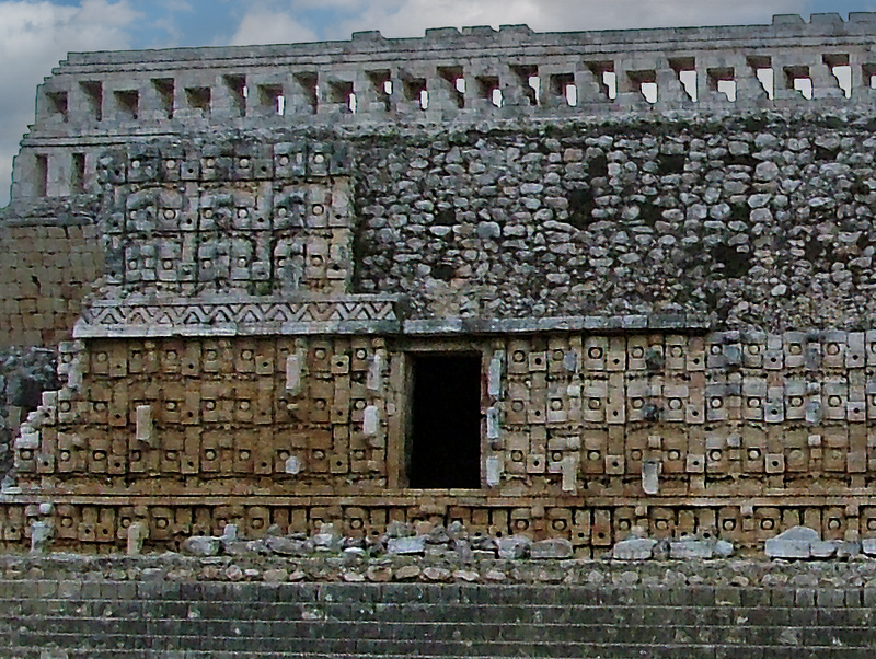 West side of the Codz Poop at Kabah showing the famous tiling of the whole building in Chaac Masks