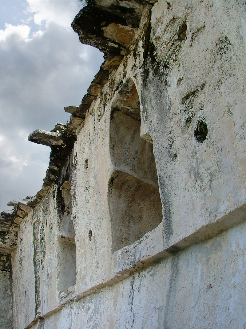 Keyhole shaped niches exposed in the ruined interior walls of Palenque Palace